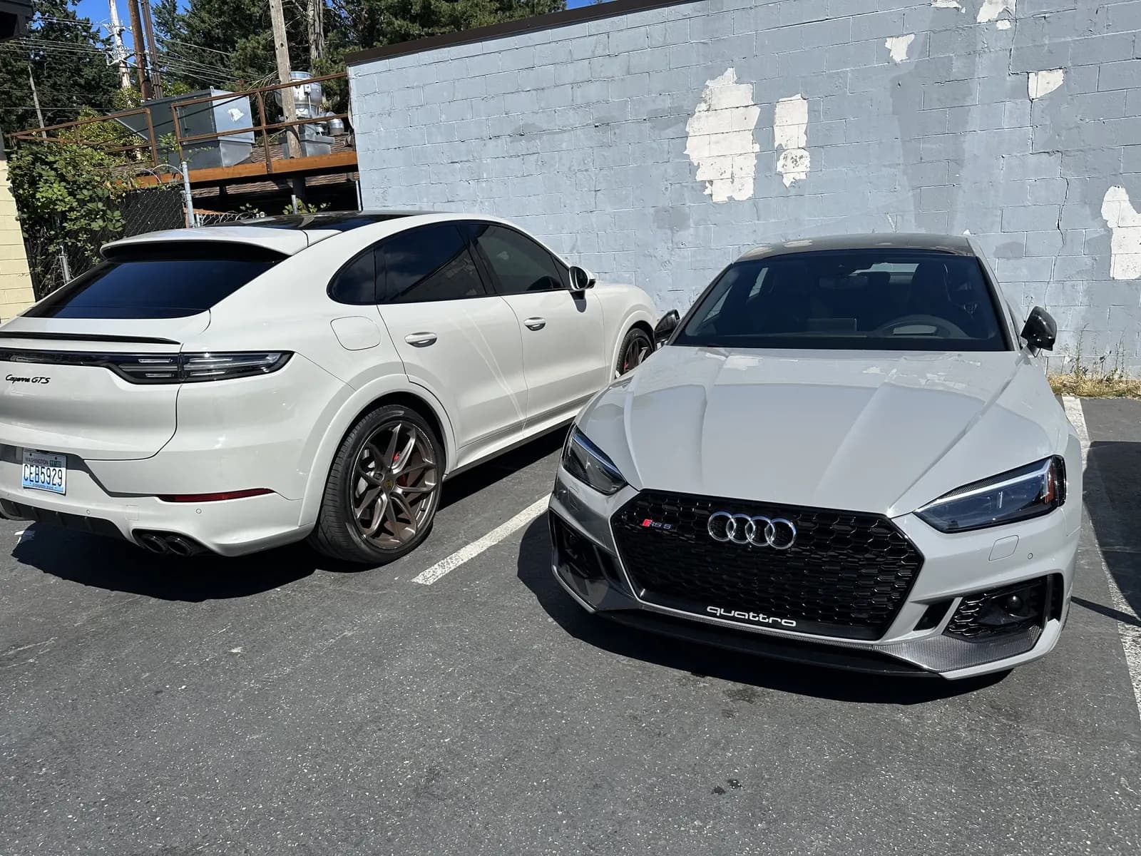 White Porsche and Audi parked together