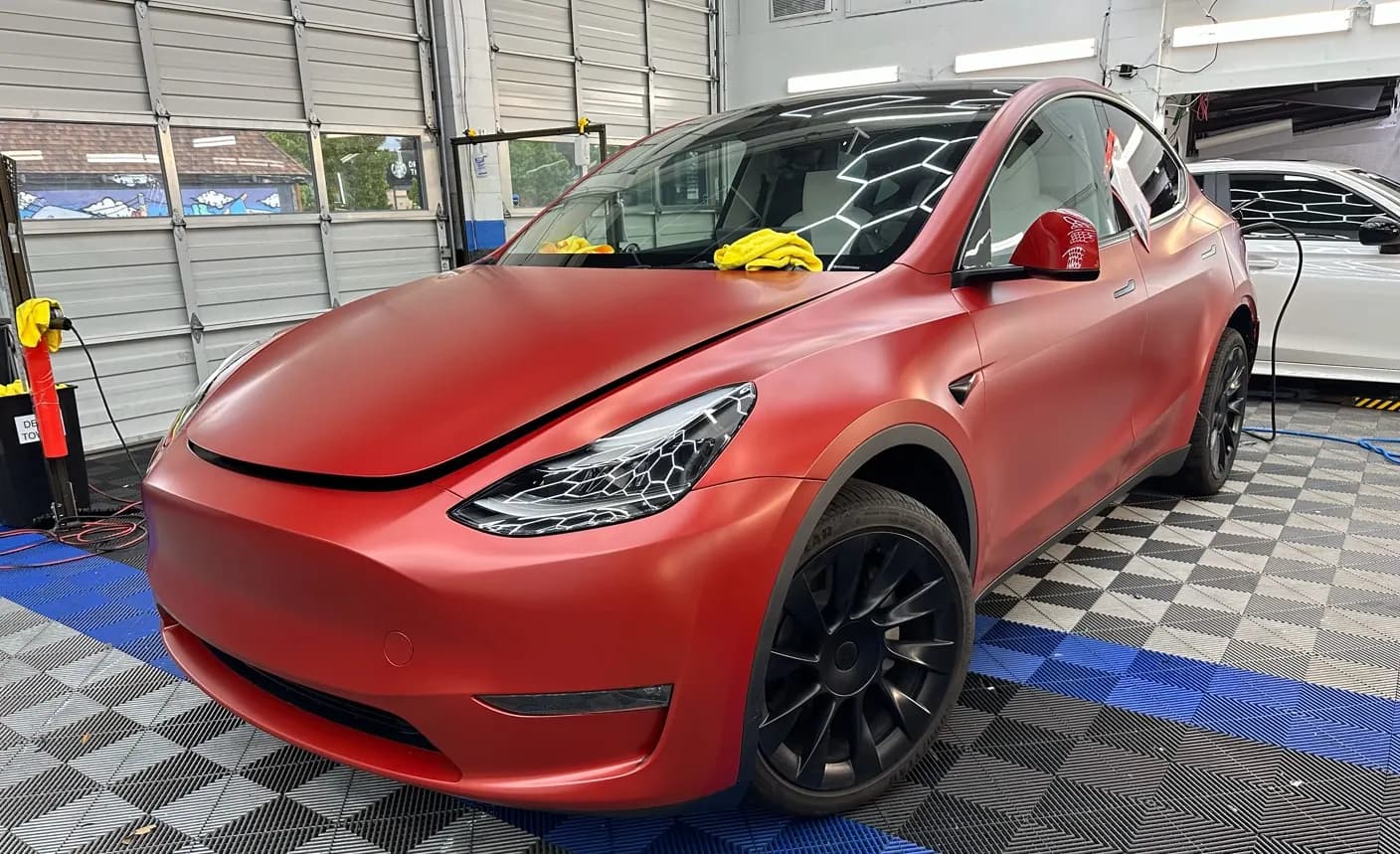 Red Tesla Model 3 in the shop with paint protection film